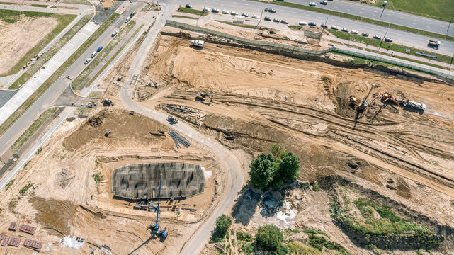 concrete pouring at construction site over reinforcing steel bars for strong foundation. aerial view.