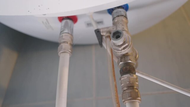 Close Up of Water Heater Shut Off Valve and Pipe Connections | Cold Water Supply Fitting for Home Boiler Installation | Plumbing Repair and Maintenance