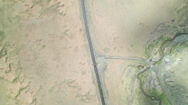 Drone view of straight asphalt road in desert area in snowing day, 4k real time footage b roll travel concept. 