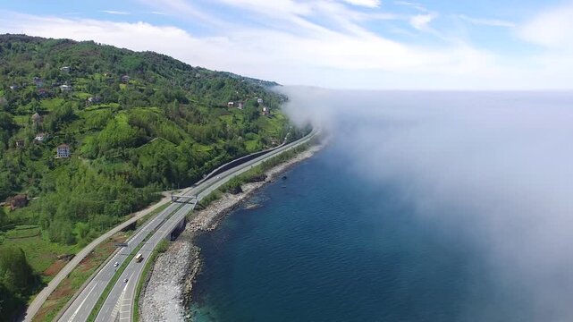Rize Turkey Black Sea coastal highway curves beside forested shoreline and calm water.