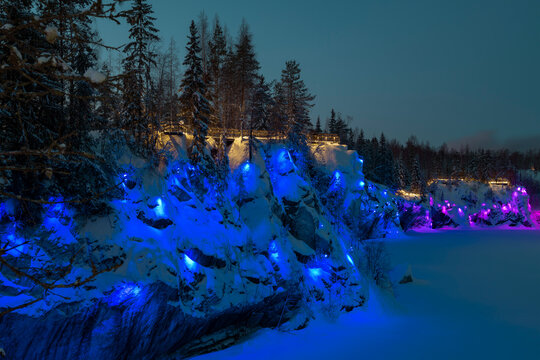 Illumination of the wall of the Marble Canyon on January evening. Ruskeala Mountain Park. Karelia, Russia