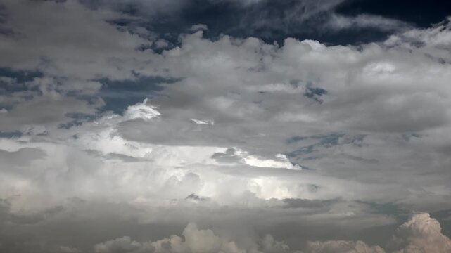 Timelapse clouds drift across a blue sky with layered partly cloudy weather.