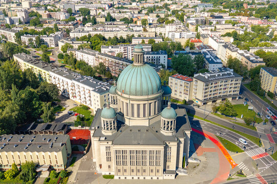Aerial view of St. Teresa and St. John Bosco Church with its prominent green dome, surrounded by urban residential buildings, green trees, and city streets in Lodz, Wojewodztwo lodzkie, Poland.