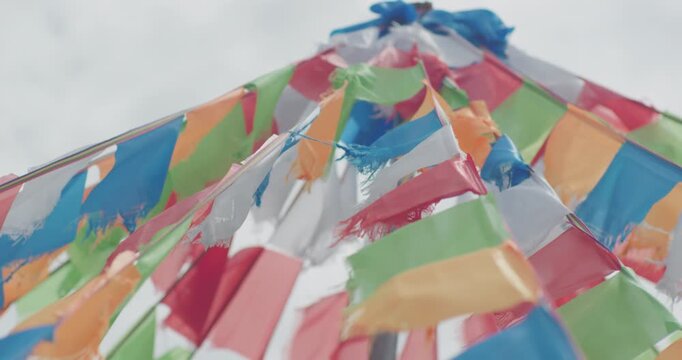 Colorful prayer flags fluttering in wind on Inner Mongolia grassland