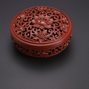 Round cinnabar lacquer box with deeply carved scrolling vines
