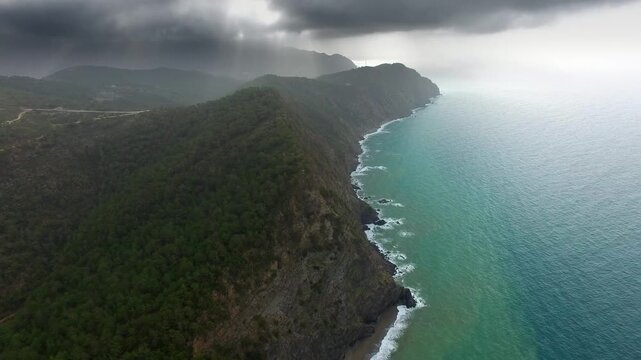 Taurus Mountains Mersin Turkey dense forests meet turquoise sea along rugged coastline.