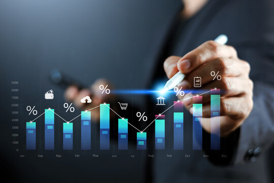 Businessman using digital pen to analyze business growth, financial interest rates, and investment data chart. Concept of corporate banking, market trend analysis, and online trading strategy.