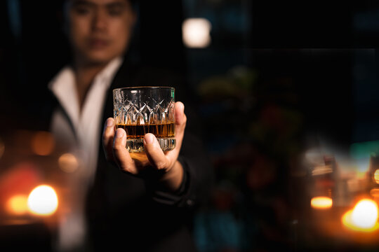 Closeup businessmen holding a glass of whiskey