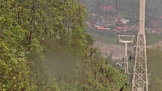 Scenic view of the Manakamana Cable Car traveling through the lush green mountains of Gorkha, Nepal. The ropeway connects visitors with the famous Manakamana Temple, a major Hindu pilgrimage