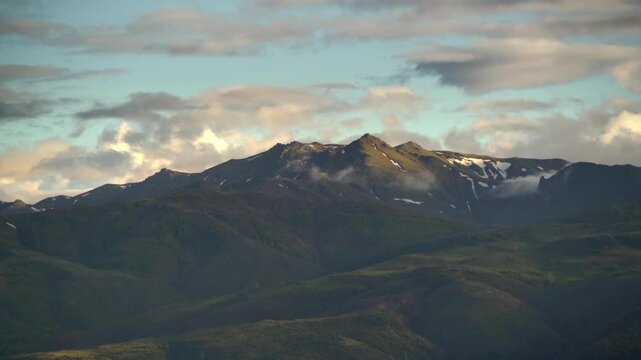 Timelapse winter mountains Ural Mountains snowy peaks fast moving cold weather broad terrain detail.