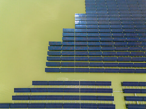 Aerial view of the Sirajganj 68MW Solar Park with rows of floating solar panels arranged on the water surface in Sirajganj, Rajshahi Division, Bangladesh.