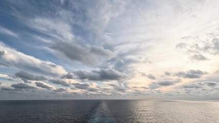 Fototapeta premium Stunning sunset over calm ocean from cruise ship