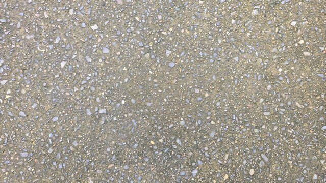 Exposed aggregate concrete floor texture for outdoor walkway. Top view of seamless washed gravel concrete pavement, showcasing detailed small pebble stone texture.