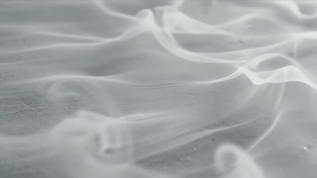 Abstract slow motion transition fading from soft textured light grey surface into an infinite white void background with subtle movement