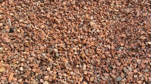 Red crushed stone gravel texture background