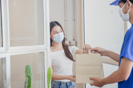 Delivery worker handing food package to customer at home doorway