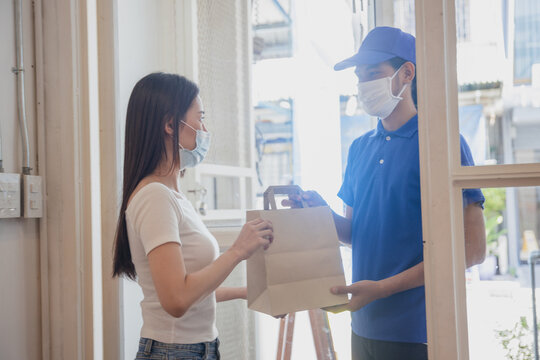 Delivery worker handing food package to customer at home doorway