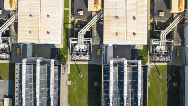 Aerial view of an industrial facility with large rooftops, cooling towers, and complex piping systems in Dayville, Killingly, Connecticut, United States.