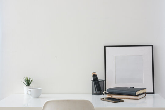 Blank laptop screen displayed on a minimal home office desk for a digital mockup.