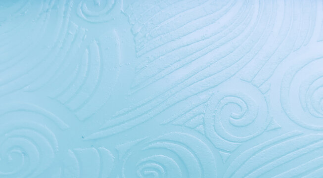 Elegant light blue background with embossed abstract wave patterns and swirling fluid texture.