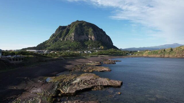 Aerial drone footage of Sanbangsan mountain near Sagye Beach, Jeju Island, South Korea.