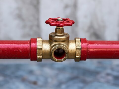 Red pipeline with golden valve and junction.