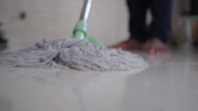 Cleaning the floor with a mop in a home setting