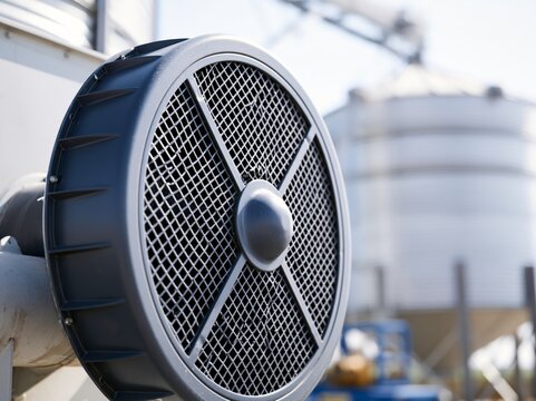 Industrial fan detail on a storage silo facility, capturing the essence of agricultural infrastructure and modern farming technology.