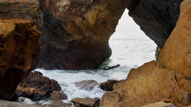 Beautiful rocky coast on the Atlantic coast. The famous Portuguese Ursa Beach. Beautiful panorama of the Rocky shore with incoming turquoise waves. Beautiful seascape on the background of rocks.