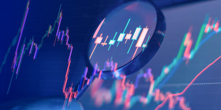 Magnifying glass focusing on financial stock market candlestick chart. Business analysis and cryptocurrency trading concept.