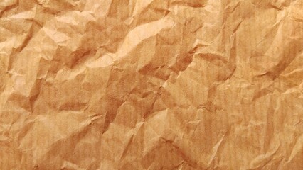 Fototapeta premium Crumpled brown paper texture background close up