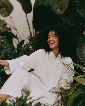 Enthusiastic Woman Joyfully Cultivating Her Flourishing Garden, Embracing the Scent of Fresh Blooms and the Warmth of Sunlight