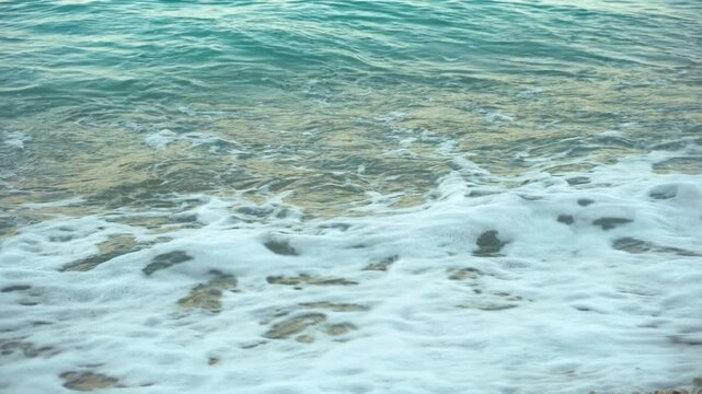 Waves splash on the shore of a tropical beach
