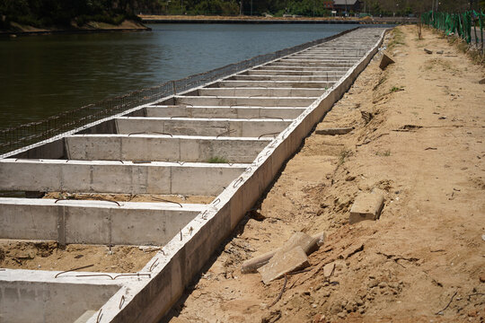 Building process city levee. Exposed foundation rebar grid at site, standing formwork and concrete footings
