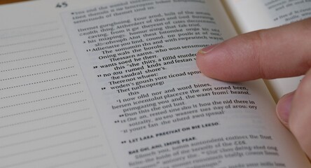 Obraz premium Close up of finger pointing text in Bible with copy space on left, featuring Bible Study and Bible Reading, with Bible Devotion, with detailed modern composition, for commercial use, for editorial use