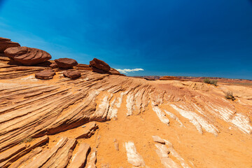 Layered Sandstone and Boulders in an Arid Desert Under a Deep Blue Sky © J Westermann-Blawert