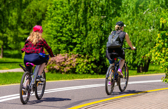 Cyclists ride on the bike path in the city Park
