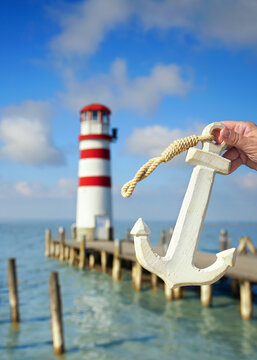 amazing lighthouse at the lake with wooden maritime anchor