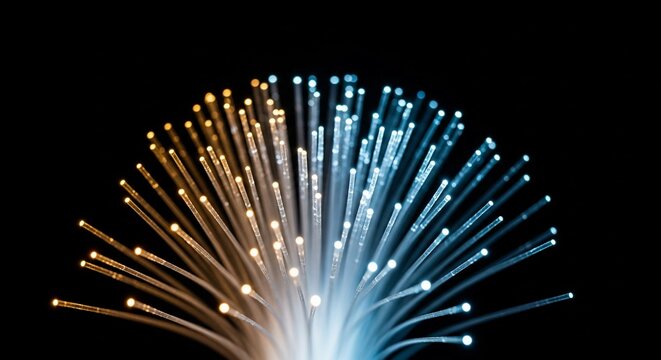 Close-up of glowing fiber optic strands illuminating the darkness with bright blue and orange lights, representing high-speed digital communication and technological advancement.
