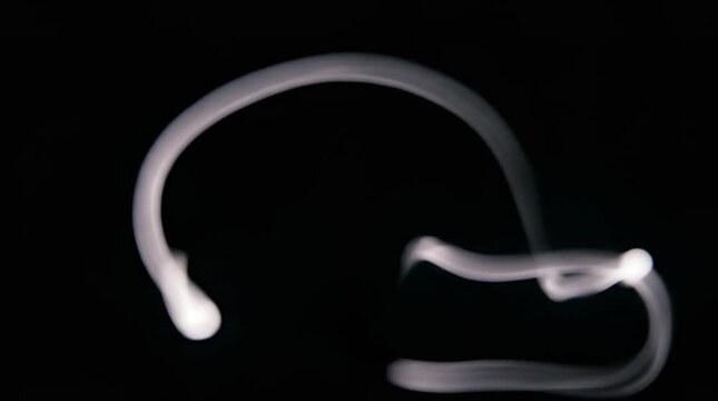 White light trails moving on black background