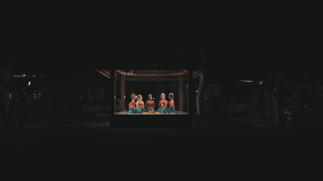 Wide Shot of Traditional Javanese Dancers in Lit Pavilion at Night