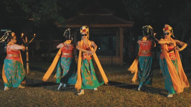 Group of Five Indonesian Dancers Performing Synchronized Routine with Sunglasses