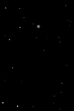 Minimal snowfall particles on black background, isolated winter effect.