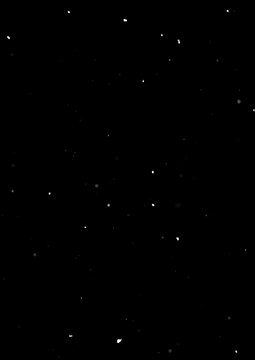 Sparse snow particles on black background, minimal winter overlay texture.