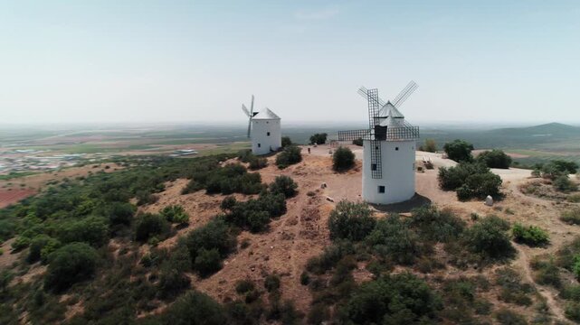 White windmills standing on hill in la mancha spain