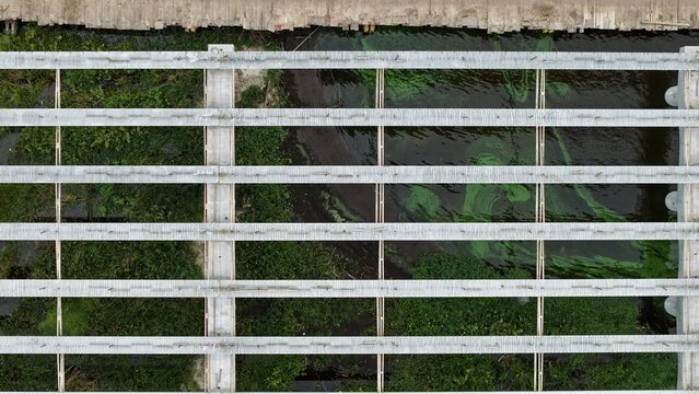 Aerial view of the Shands Bridge construction site featuring concrete beams spanning over water and marshy vegetation in St. Augustine, Florida, United States.