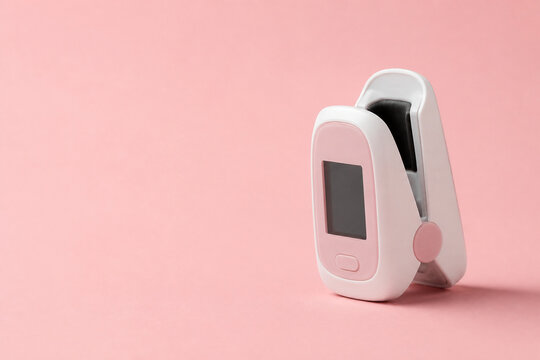 Generative AI image of a single unbranded pulse oximeter clip standing open on a seamless warm blush background in minimal medical stock photography with clean commercial copy space.