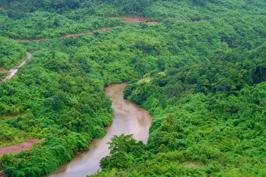 Winding River Flowing Through Lush Green Forested Hills