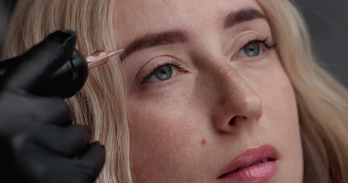 Young caucasian woman smiling in beauty studio portrait closeup with slight head shift and steady tracking after cosmetic procedure permanent makeup.