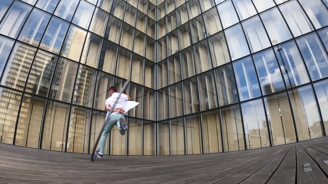 Dynamic and vibrant performance of a Cyr Wheel within urban architecture. Concept of individuality, creativity and self-confidence